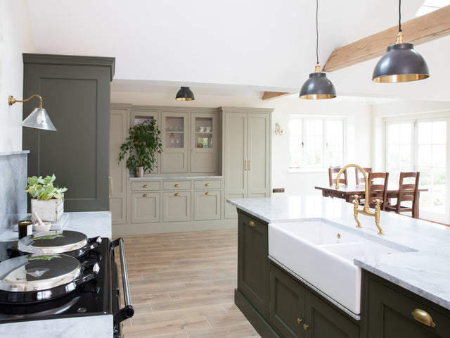 A bright open kitchen decorated with different green tones 