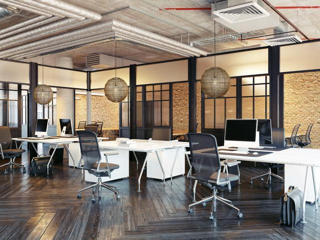 Wire pendant lights hanging over desks in an office