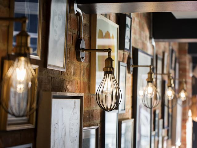 Industrial style wire cage wall lights in a restaurant. 