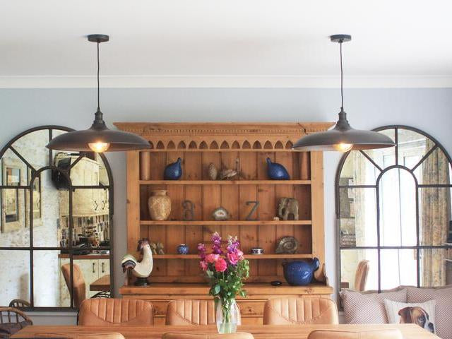Two giant pendants over a dining table. 