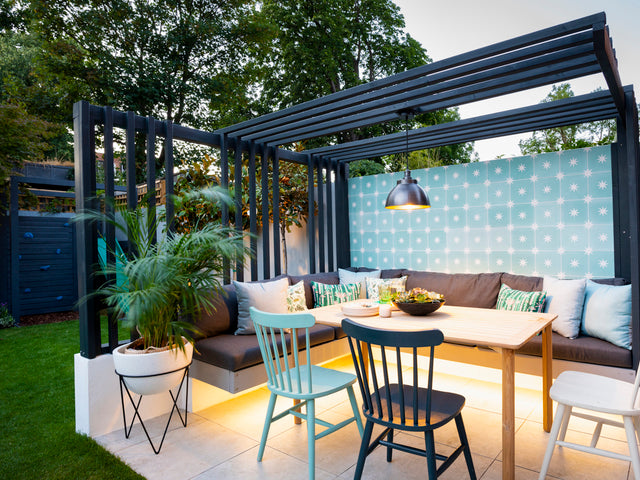 An outdoor seating area illuminated by a pendant light