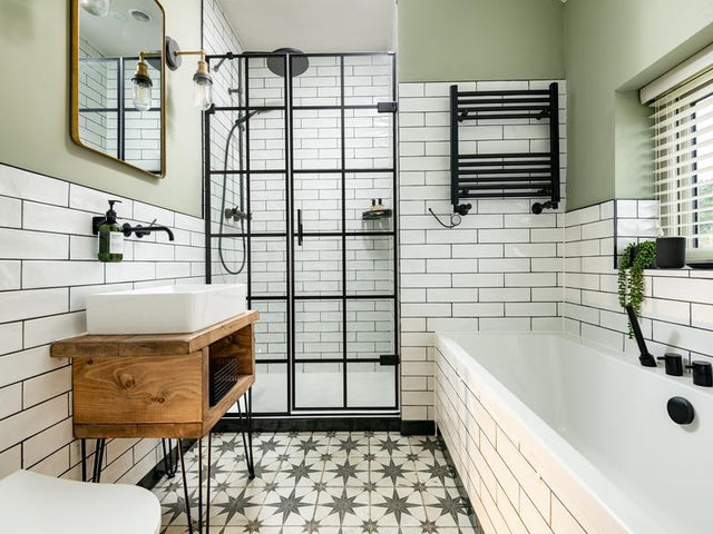 A white and green bathroom with patterned tile flooring