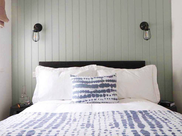 A simplistic nautical bedroom interior with industrial wall lights by Industville