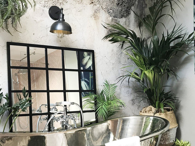 Jungle inspired bathroom decor with waterproof wall light
