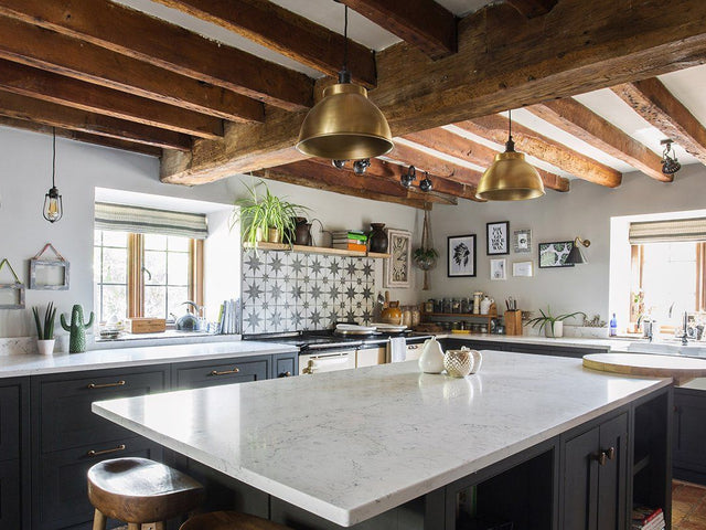 A rustic kitchen interior with industrial lighting by Industville