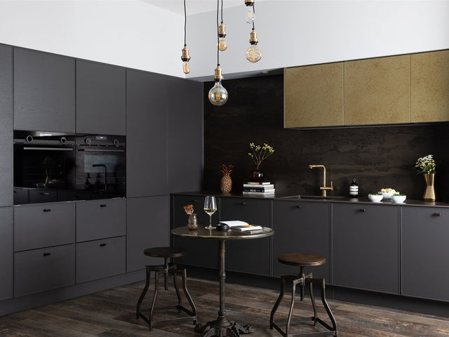 A dark modern interior with large bulb lighting by Industville
