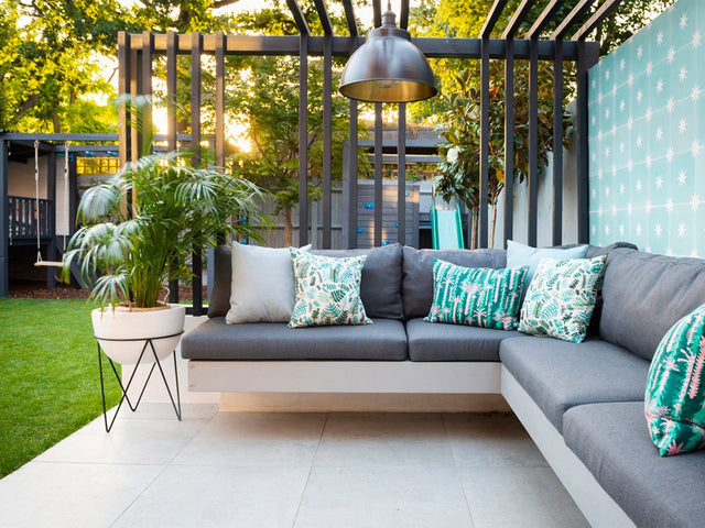 A modern garden design with sofa and industrial light