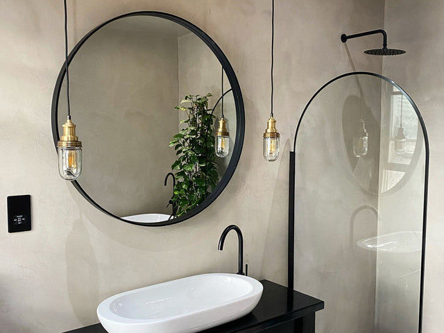 A modern minimalist bathroom interior with hanging lights by Industville