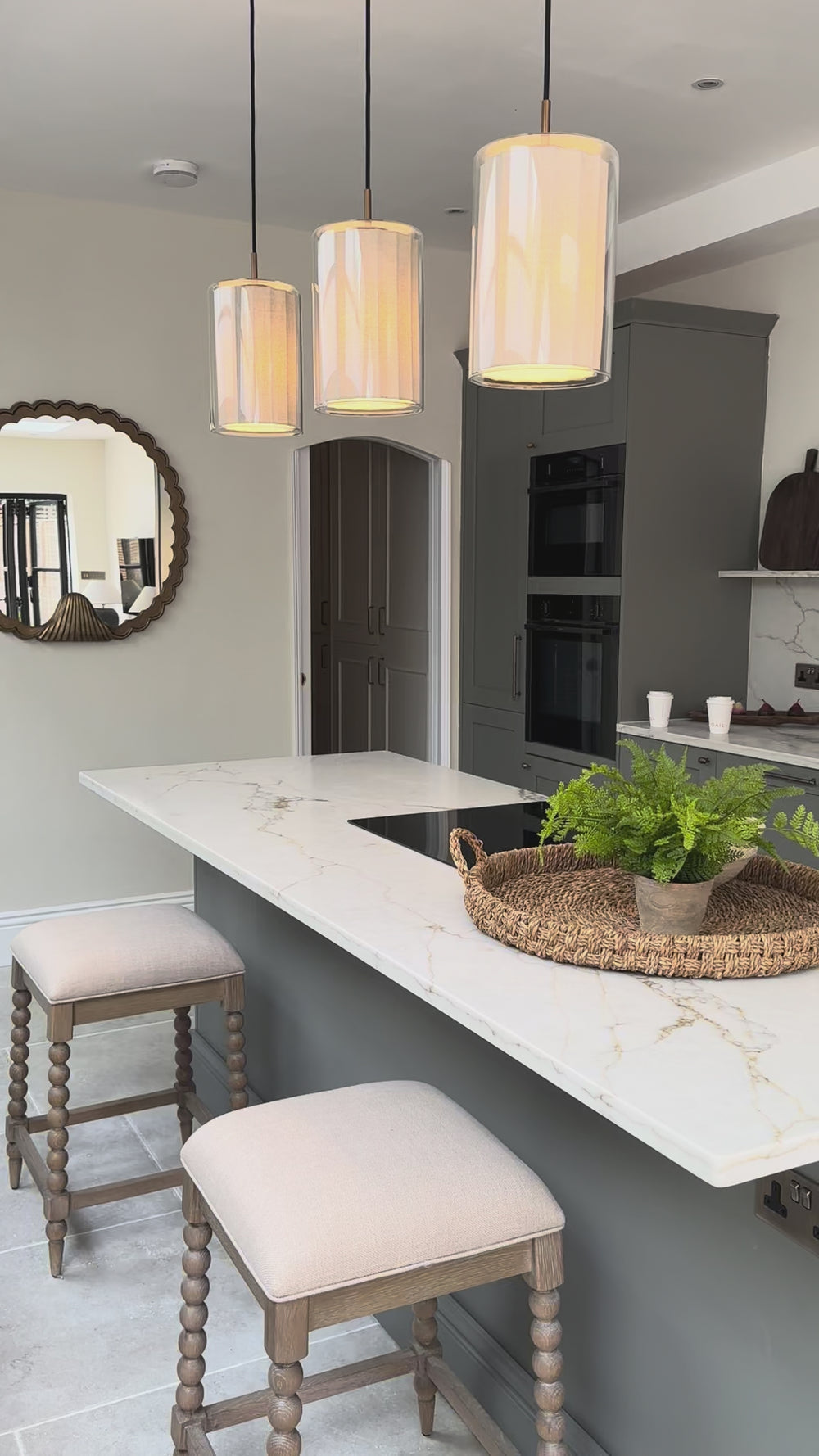 Bude Cylinder Linen Pendant Light in Clear Glass lit up in a kitchen setting